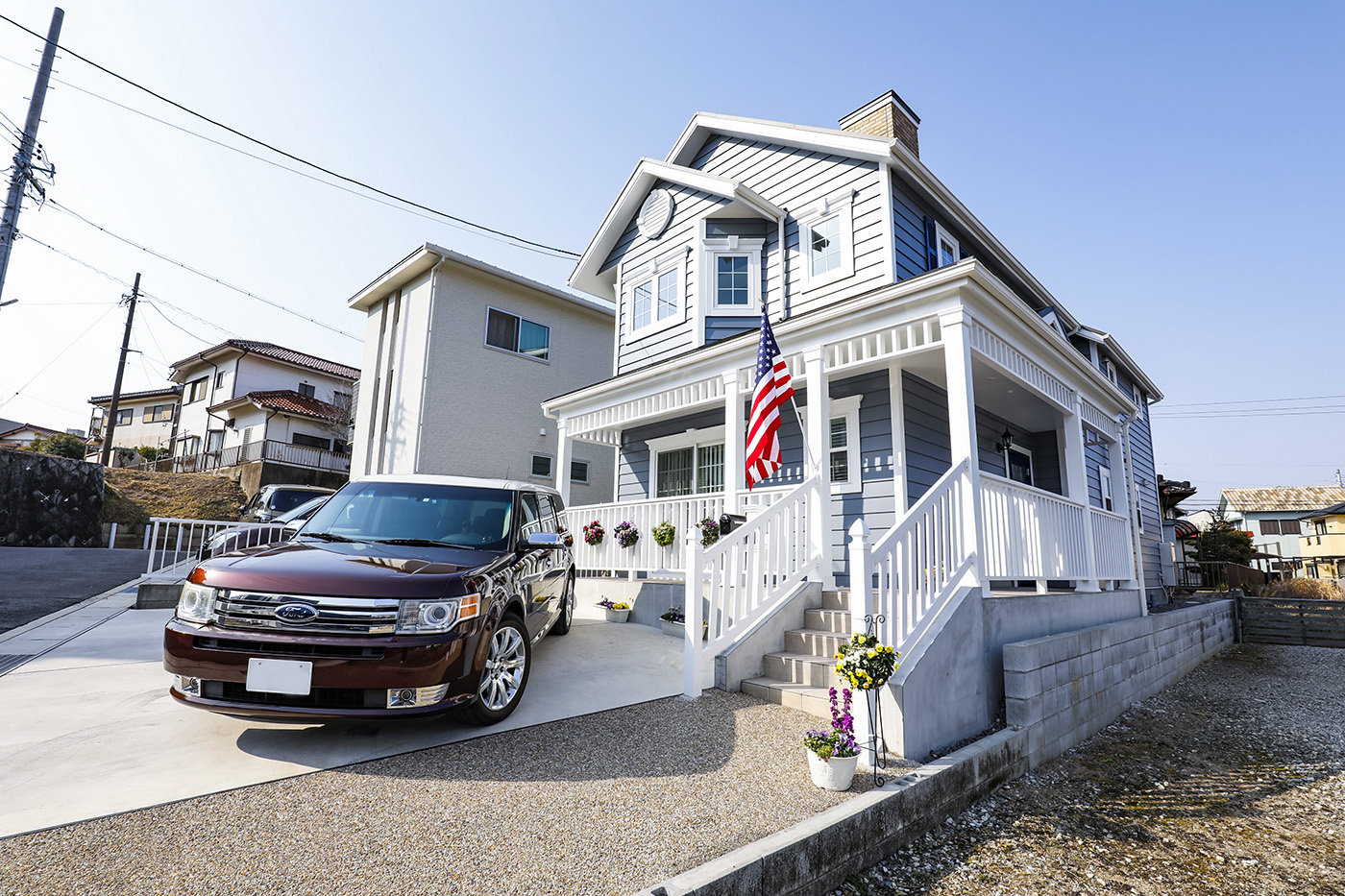 ジェネラルアメリカンホーム【デザイン住宅、輸入住宅、趣味】外観は映画で見たアメリカンハウスそのまま。ブルーグレーのラップサイディングに白い梁を組み合わせ、煙突まで取り付けた