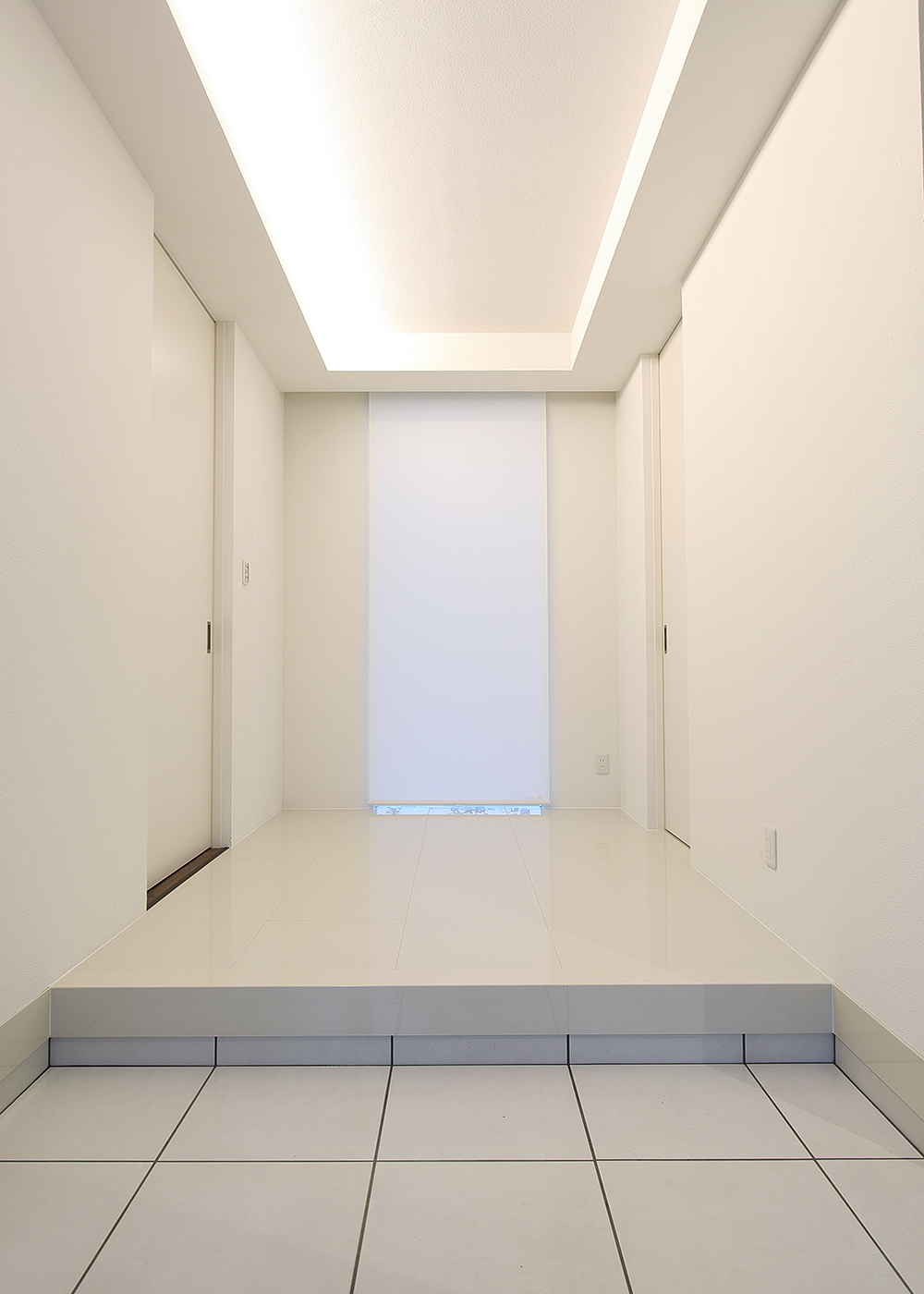 丸昇彦坂建設【デザイン住宅、間取り、ガレージ】開放感ある玄関は天井の間接照明でホテルライクな雰囲気