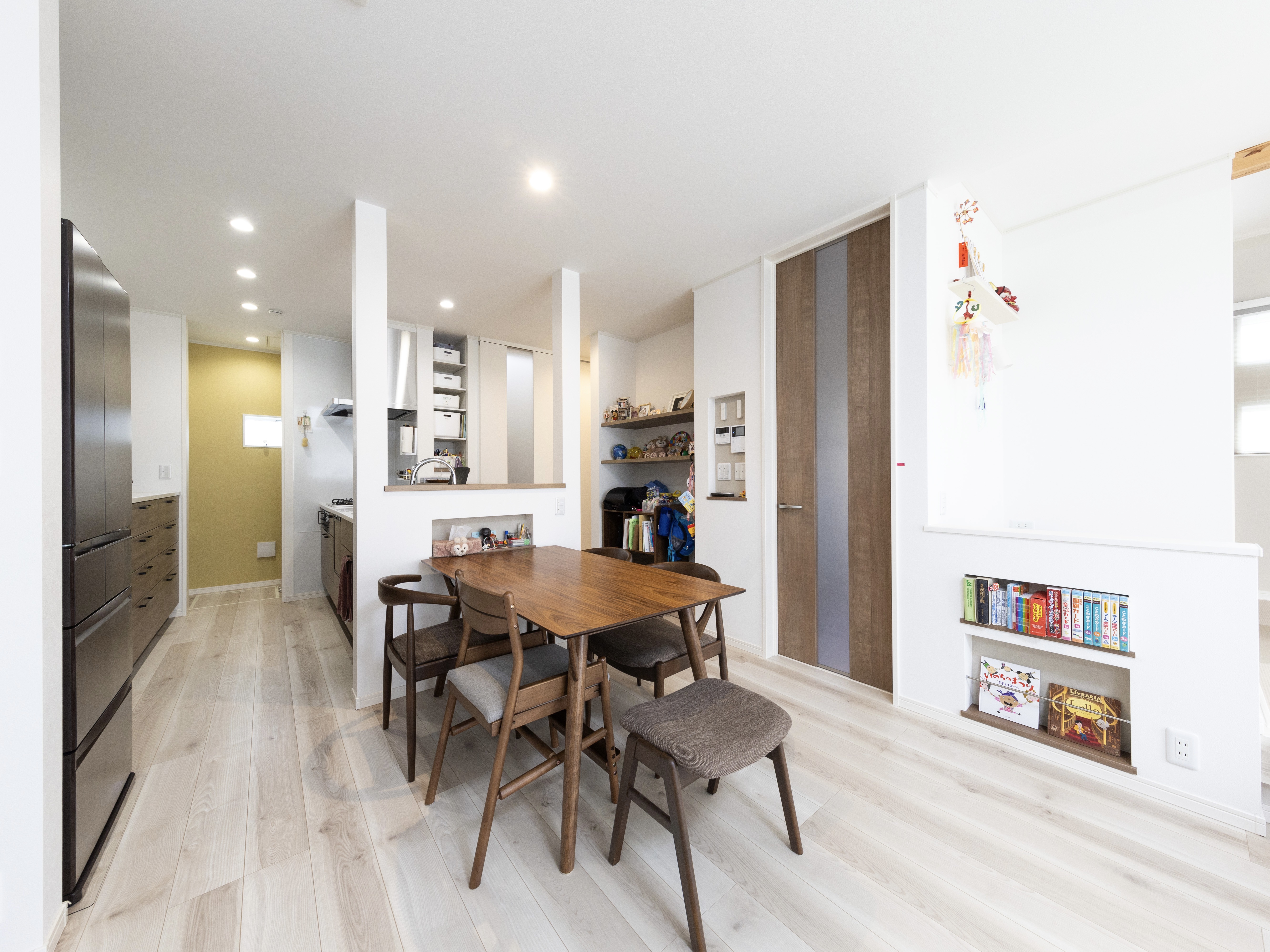 エスホーム｜明るい木目調の床に合わせたシンプルで温かみのあるダイニング。コンパクトながらも家族の交流を大切にしやすい配置で、落ち着いた雰囲気を演出している。ダイニングテーブルはキッチンと横並びに配置したことで配膳が早くなった。