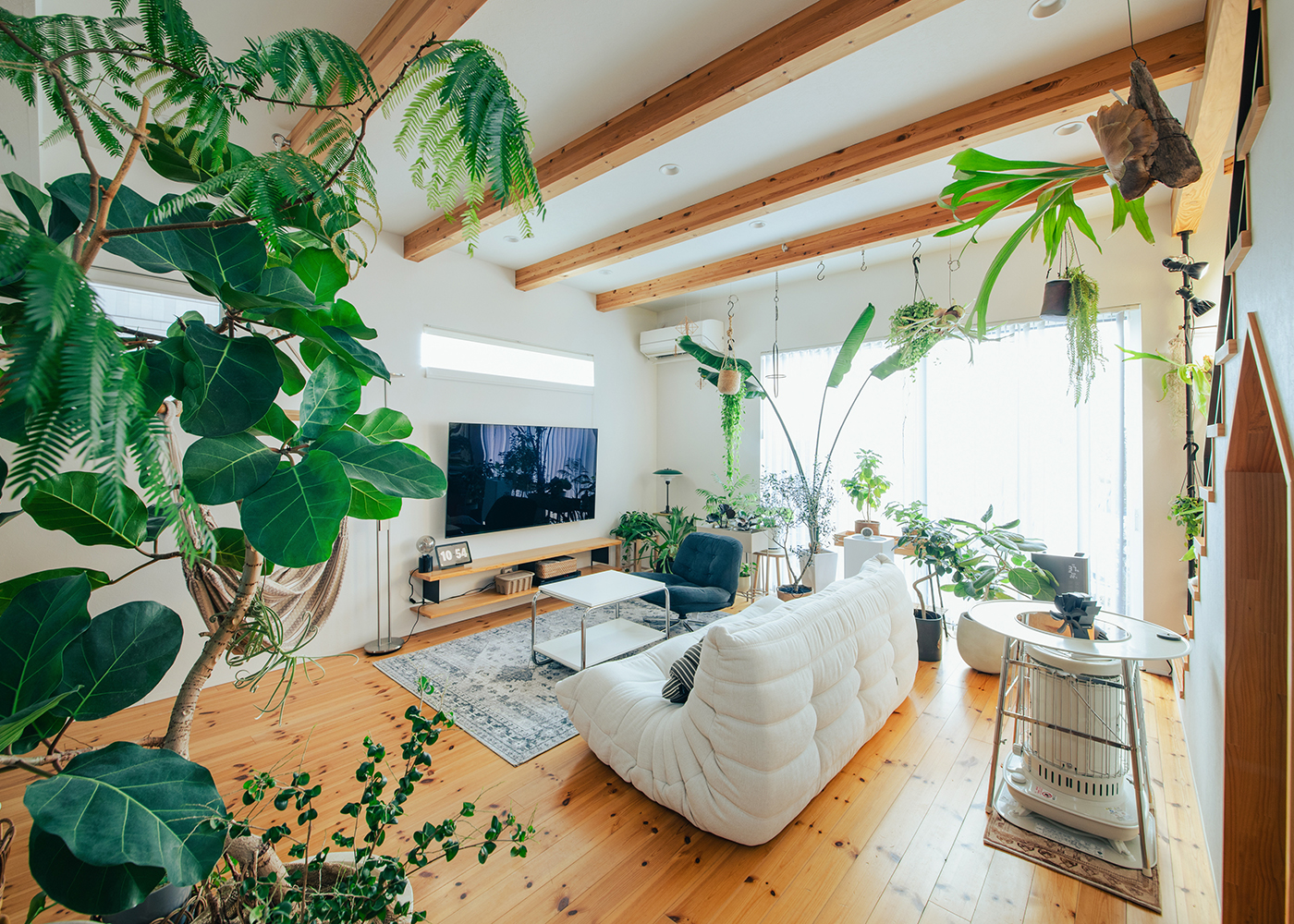 SEVEN HOUSE/セブンハウス【子育て、収納力、間取り】緑豊かなリビングには大きな窓があり、自然光がたっぷりと差し込み、心地よい空間を提供している