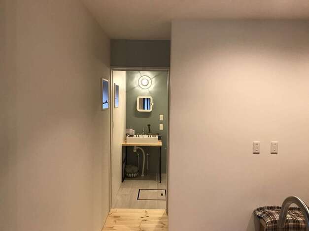 キッチンのバックヤードに水回り設備を集約。洗面台は同社の造作。子どもたちの気配を感じながら料理できるので、奥さまも安心