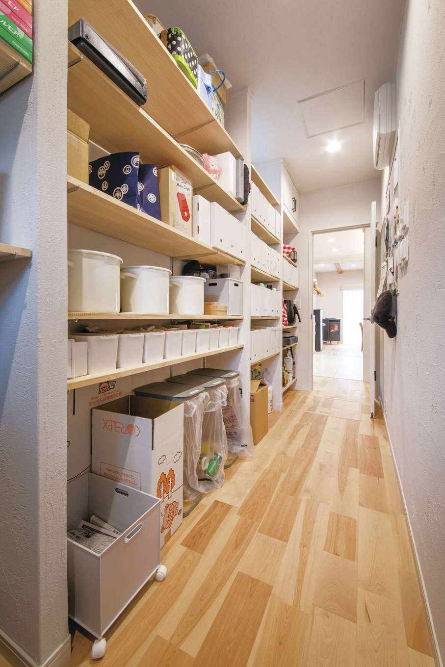 ほっと住まいる【自然素材、間取り、スキップフロア】玄関から直結する大型のパントリー。どこに何がしまってあるか一目瞭然で、しかも奥行きが浅いので物を取り出しやすい。几帳面な性格の奥さまが1つ1つのBOXにラベルを貼っているので、ご主人も娘さんも自主的に片付けるようになった