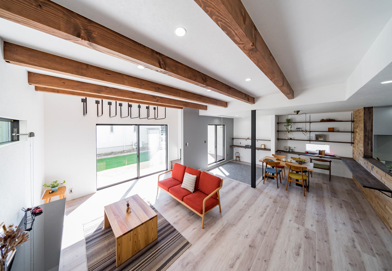 長坂篤建築研究所│nalabo（エヌエーラボ）【子育て、建築家、スキップフロア】家の中に公園があるイメージで設計したLDKはなんと27畳。ブランコやハンモックを吊るために、現しの太い梁を採用した。大きな開口部を開ければ、ウッドデッキ、庭とひとつながりに