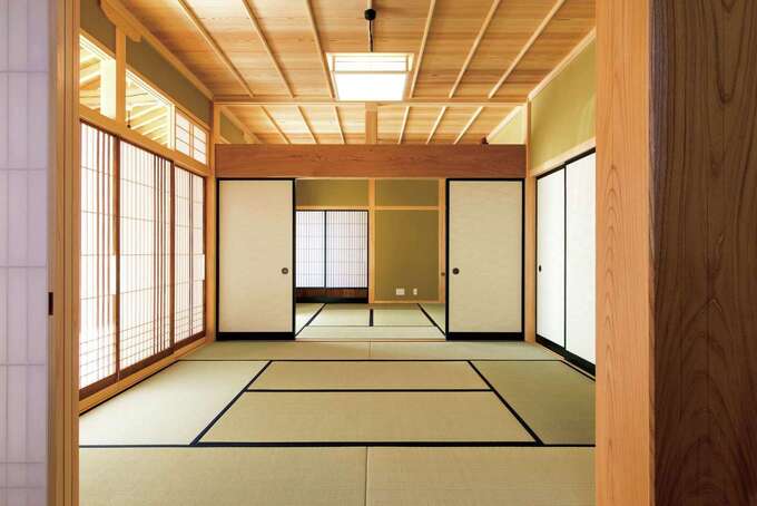 障子越しのやさしい光が、ふた間続きの和室に回り込む。スギ材の赤身できれいに収められたイナゴ天井が、品格を添える