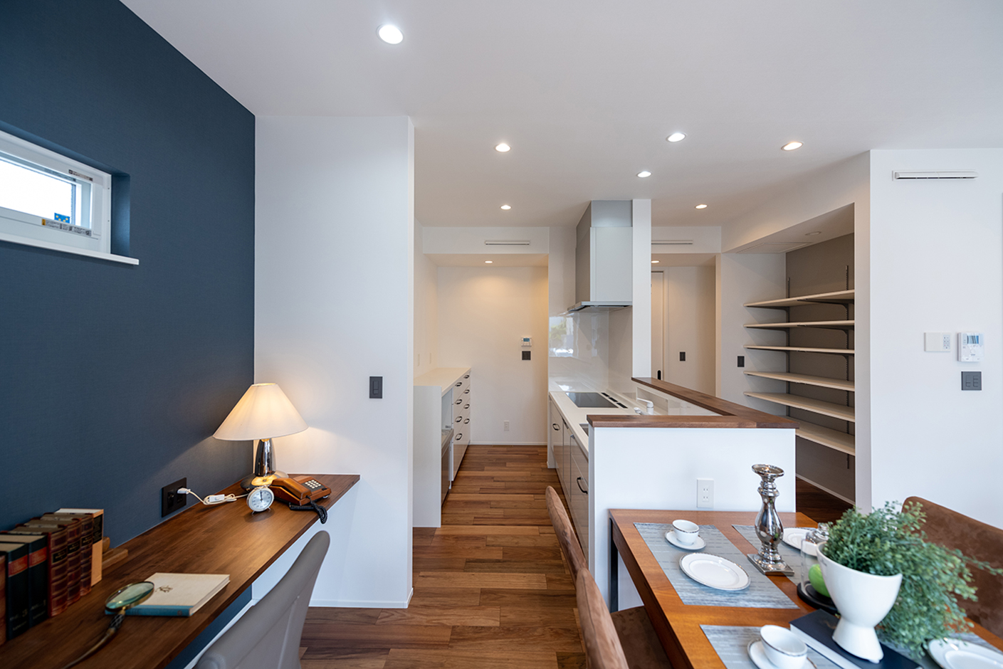 OWN RESORT HOME（オウンリゾートホーム）【デザイン住宅、趣味、間取り】家事効率を高めるアイランドキッチンを採用。キッチンのすぐ目の前には、パントリー兼クローゼットを造作した。ダイニングテーブルの背面にはワークスペースも用意