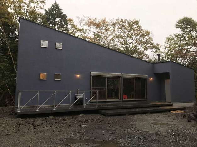 片流れのスタイリッシュな外観デザイン。雑木林を抜けて突然現れた外国のコテージのような佇まいが美しい。広い庭でライブや天体観測、BBQなど、季節ごとにさまざまな楽しみ方ができる