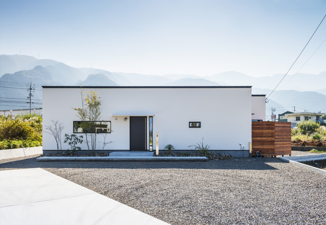 S.CONNECT（エスコネクト）【趣味、夫婦で暮らす、平屋】シンプルモダンな箱型の外観に、黒縁の窓枠が映える。ウッドフェンスの中には坪庭がある