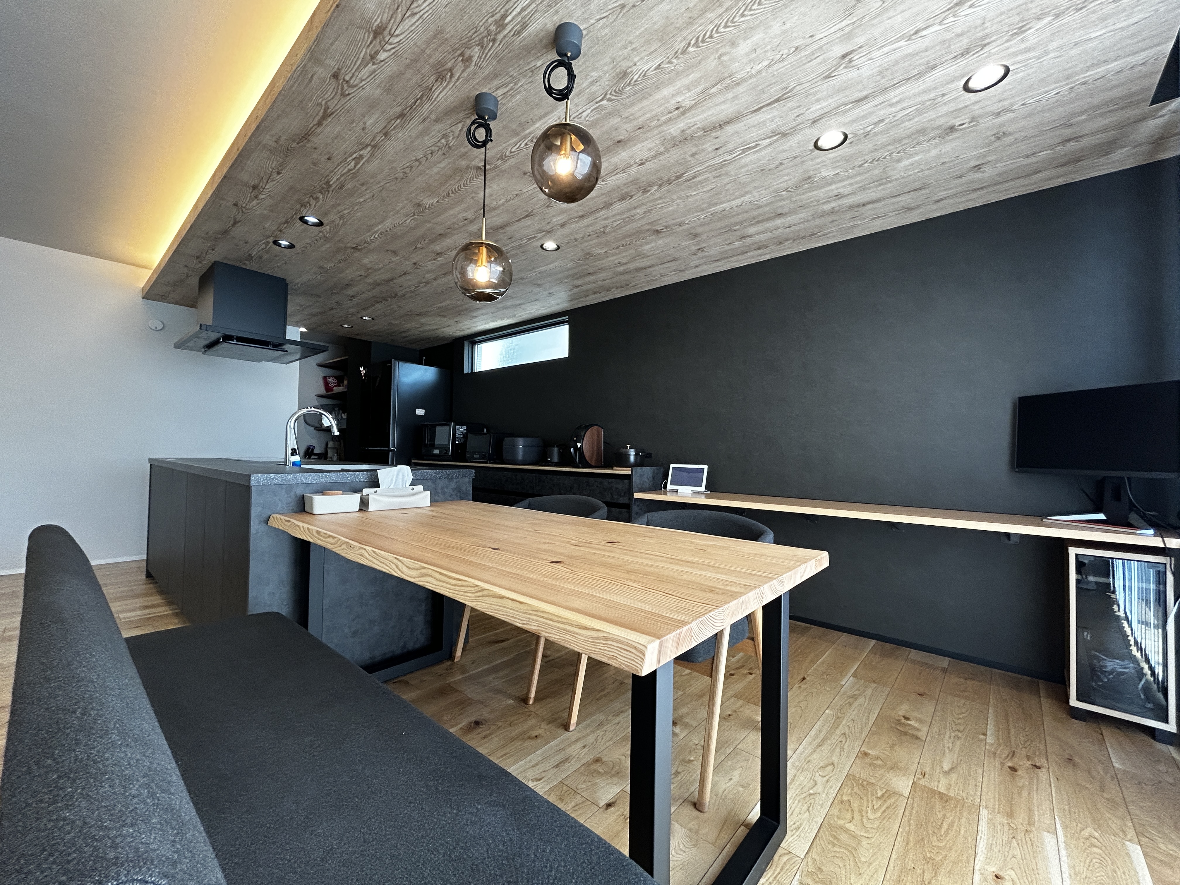 パナソニックホームズ中部第一支社 愛知第一支店・愛知第二支店｜モダンなデザインのLDK。木目調の天井と床が温かみを演出し、天井照明が落ち着いた雰囲気を醸し出す。広々とした空間で寛げる。