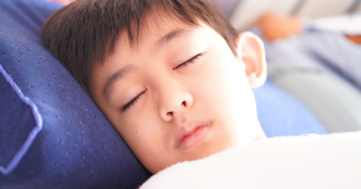 青い枕で穏やかに眠る子どもの寝顔