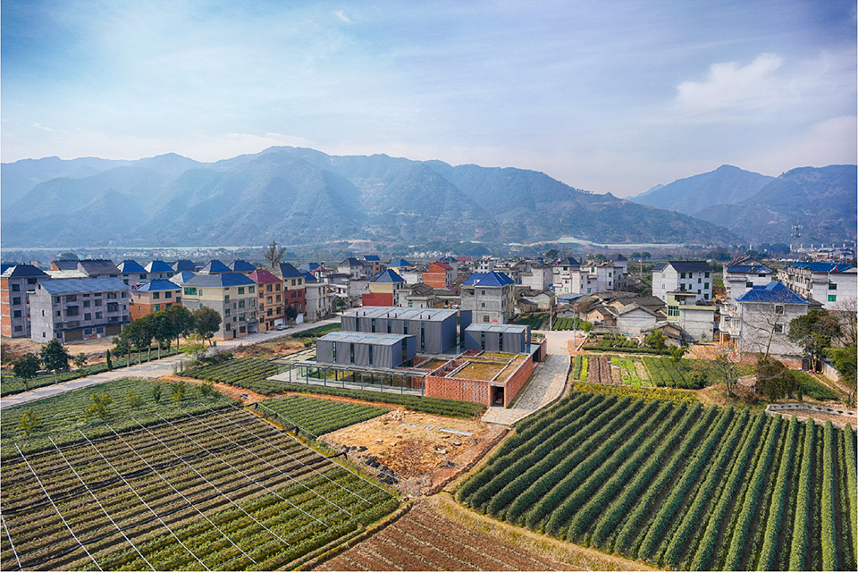 Brown Sugar Factory between village houses and cultivated fields