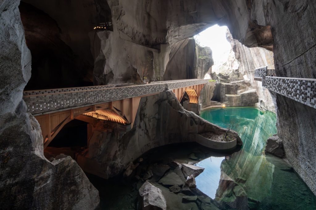 Timber arch bridges crossing a turquoise quarry pool
