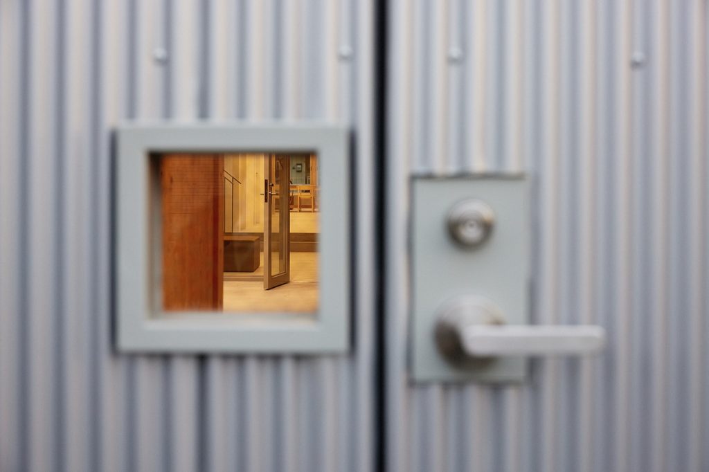 Small window and door handle in the corrugated cladding