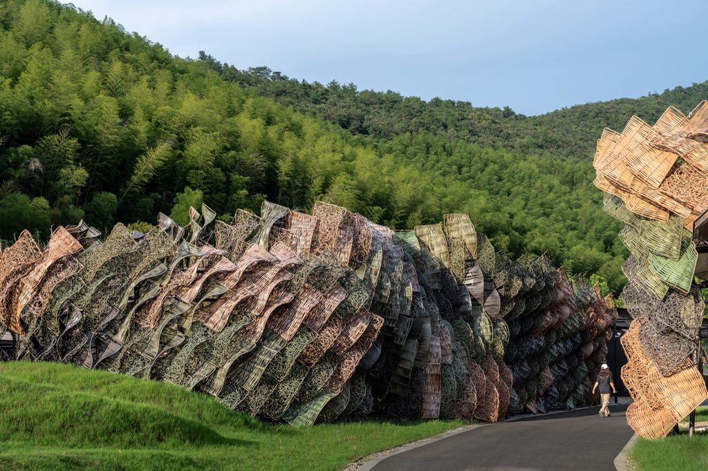 Woven HDPE aviary cladding beside the bamboo grove