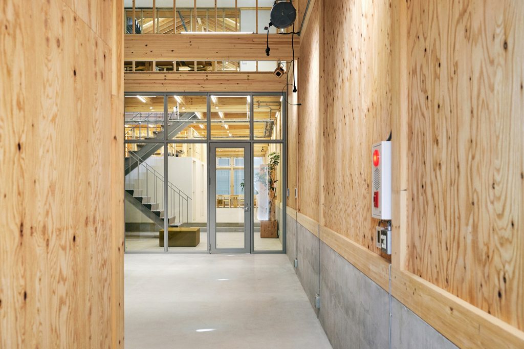 Plywood-lined entrance looking toward the street