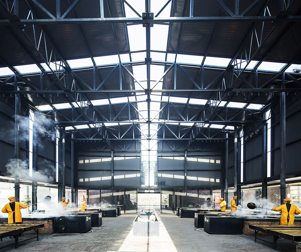 Rows of sugar-making stoves beneath the exposed steel roof