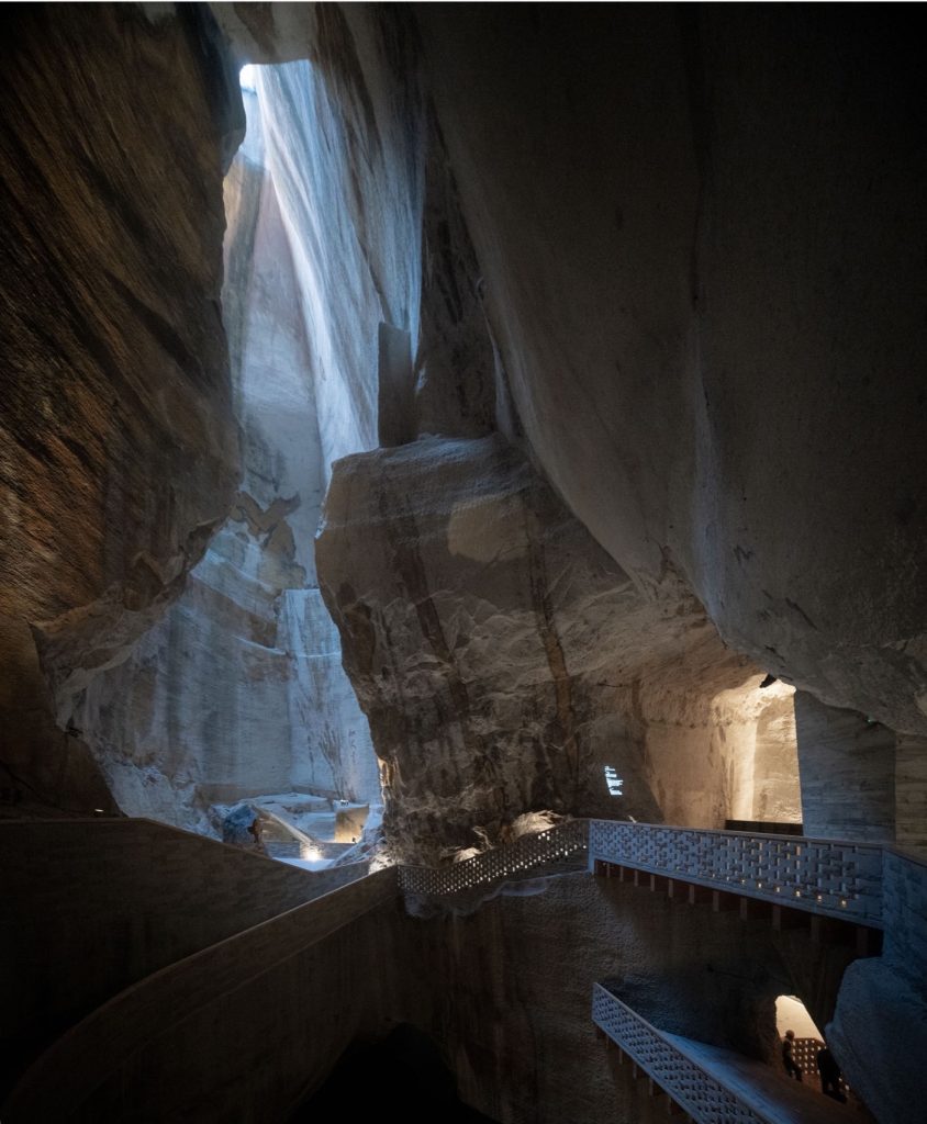 Walkways beside a tall chamber lit from above