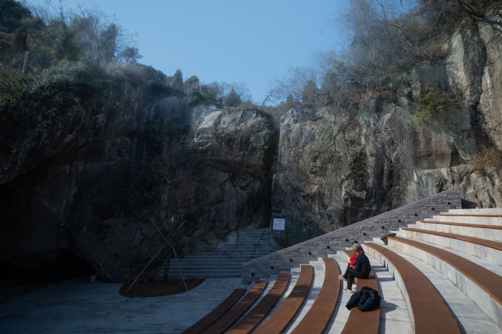 Visitors seated in the outdoor stone theater