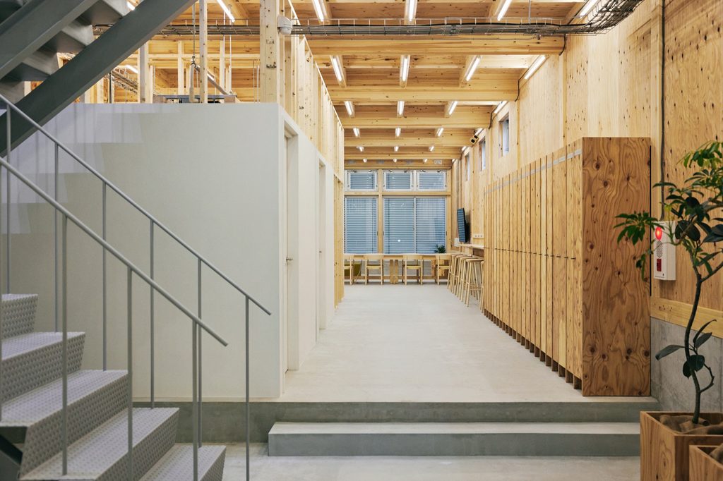Corridor along the plywood wall toward the rear