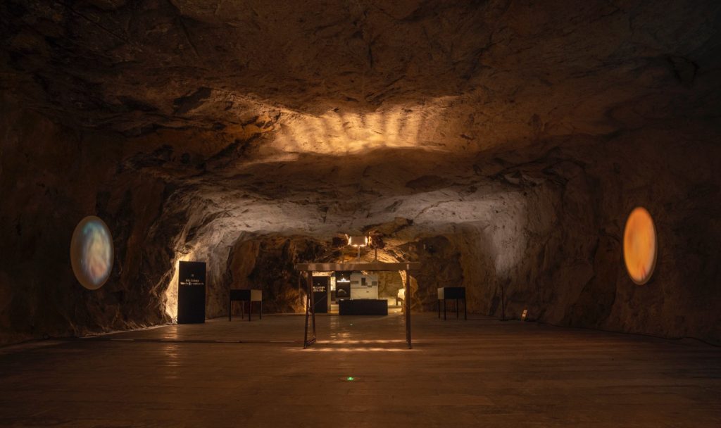 Exhibition room with illuminated rock walls