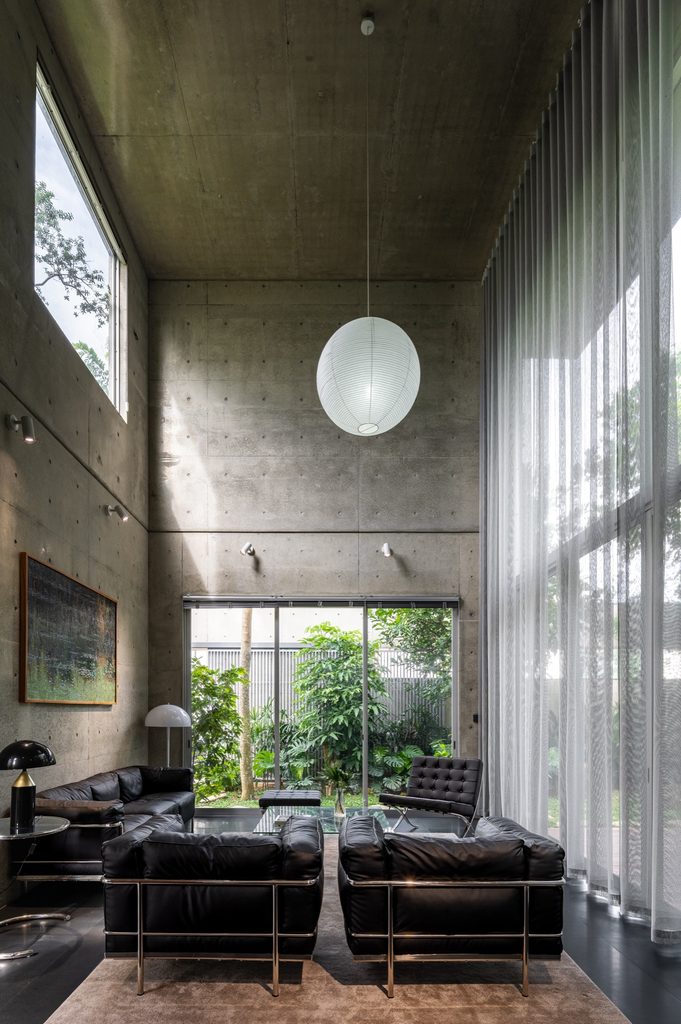 Double-height living room with sheer curtains