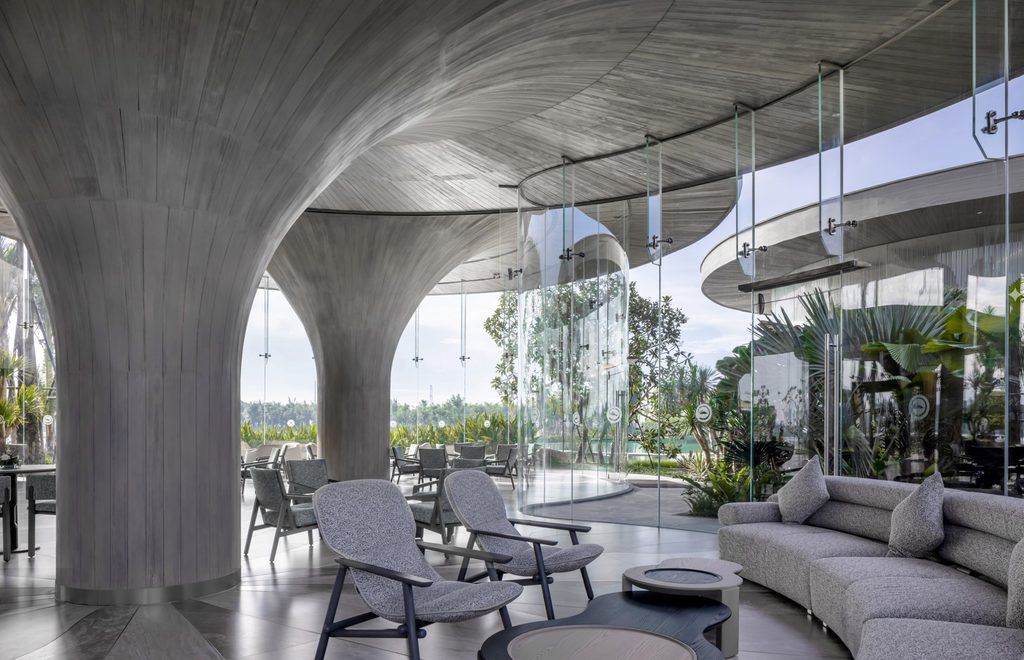 Lounge between concrete columns and full-height glass