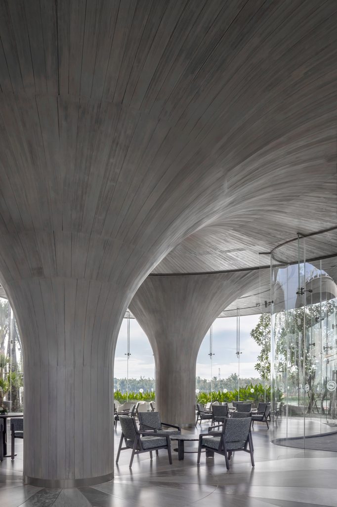 Concrete columns spreading into the ceiling over a seating area