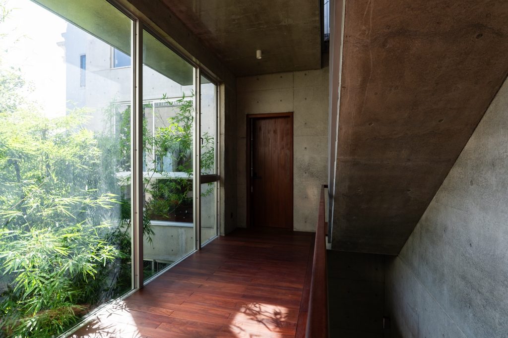Upper corridor with concrete walls and glazing