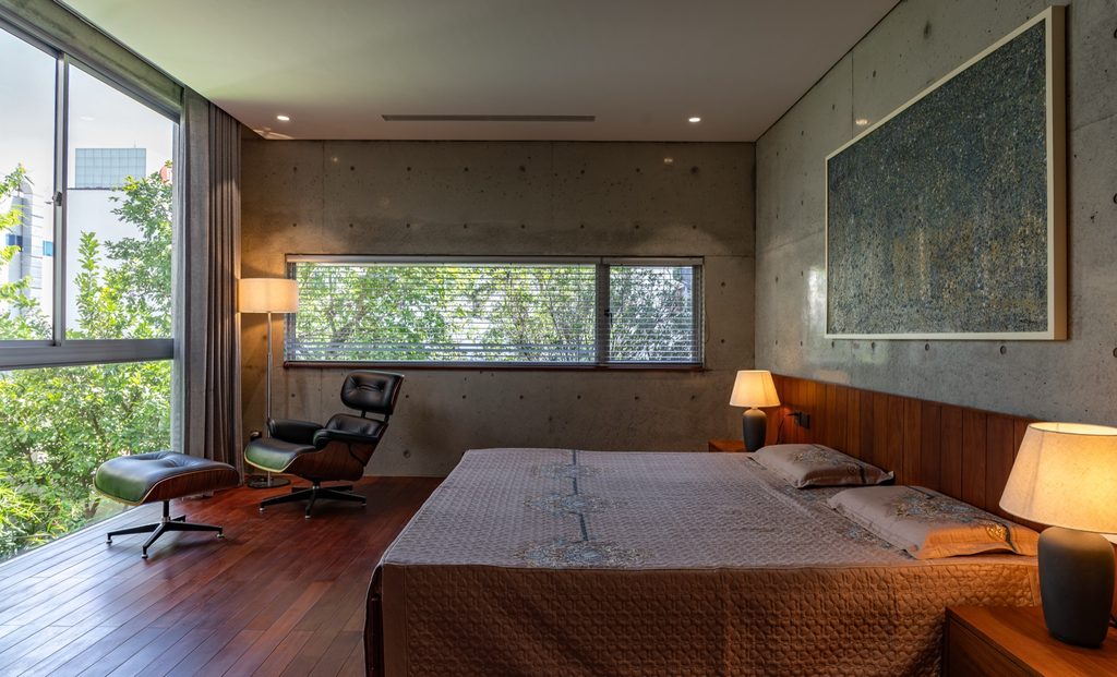 Bedroom with timber floor and a long window