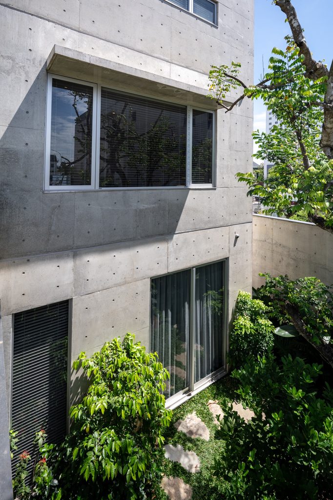 Concrete façade with planting at its base