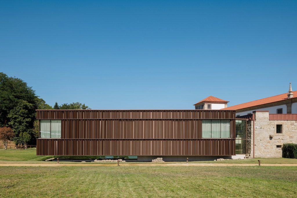 Dark vertical cladding above the glazed base of the spa