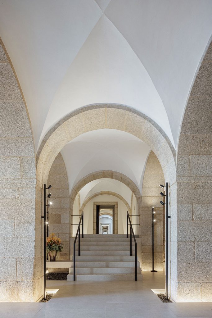 Stone steps beneath a sequence of vaulted arches