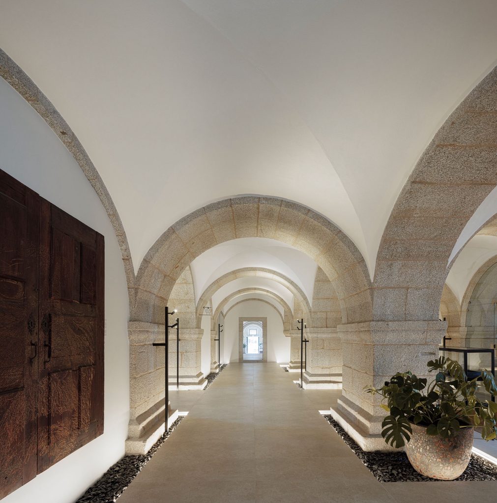Vaulted passage with stone columns and timber doors