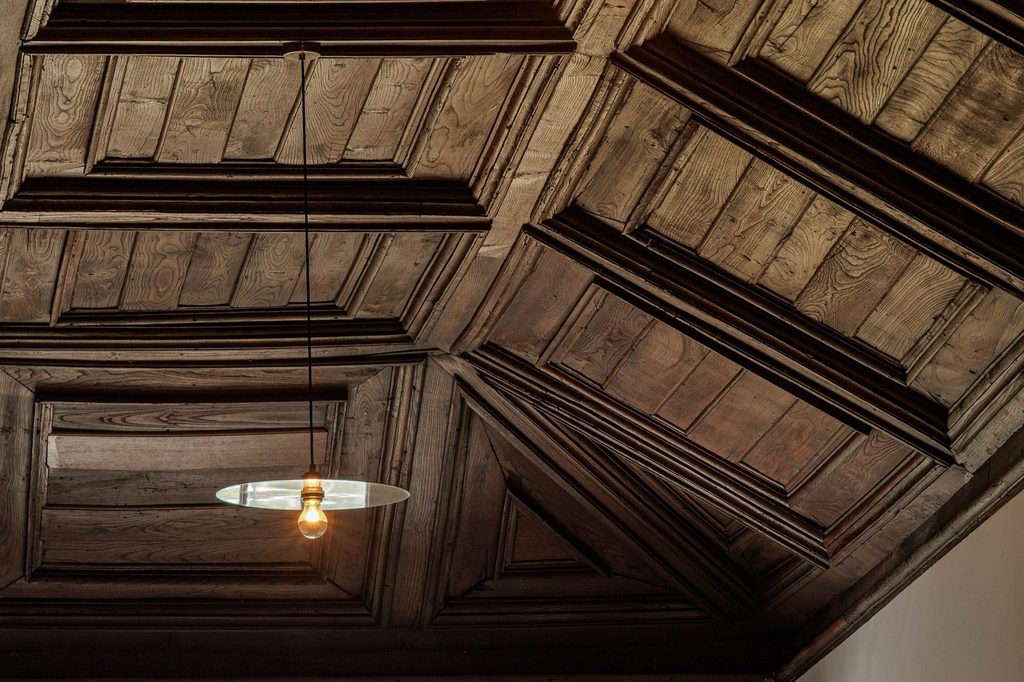 Dark timber ceiling with recessed decorative panels