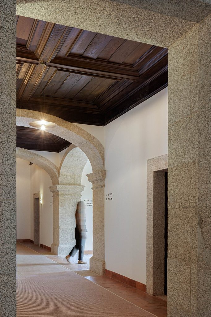 Stone doorway and arches beneath a dark timber ceiling