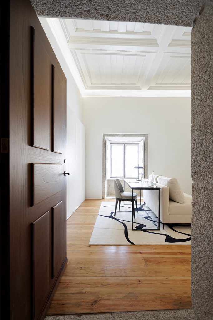 Stone doorway opening into a guest room with a desk