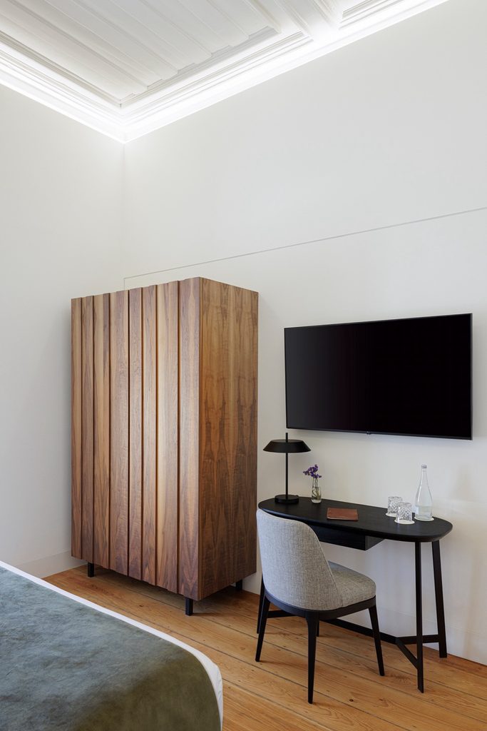 Timber wardrobe and desk beneath a white ceiling