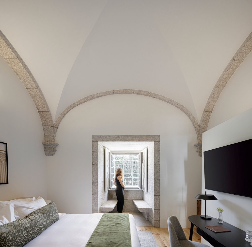 Guest room beneath stone ribs with a window seat
