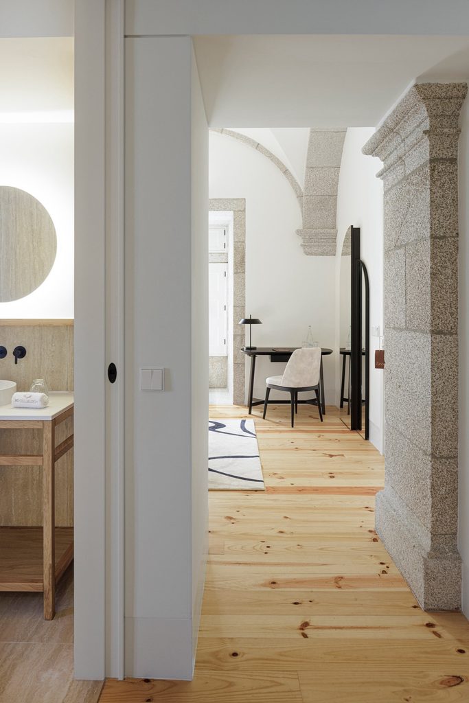 Bathroom doorway opening towards a guest room