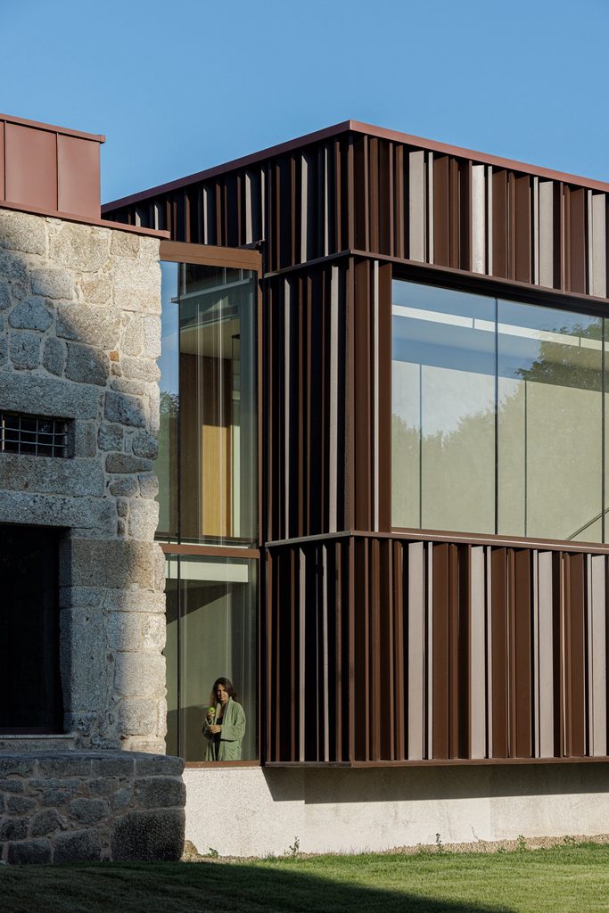 Glazed corner and vertical cladding beside historic stonework