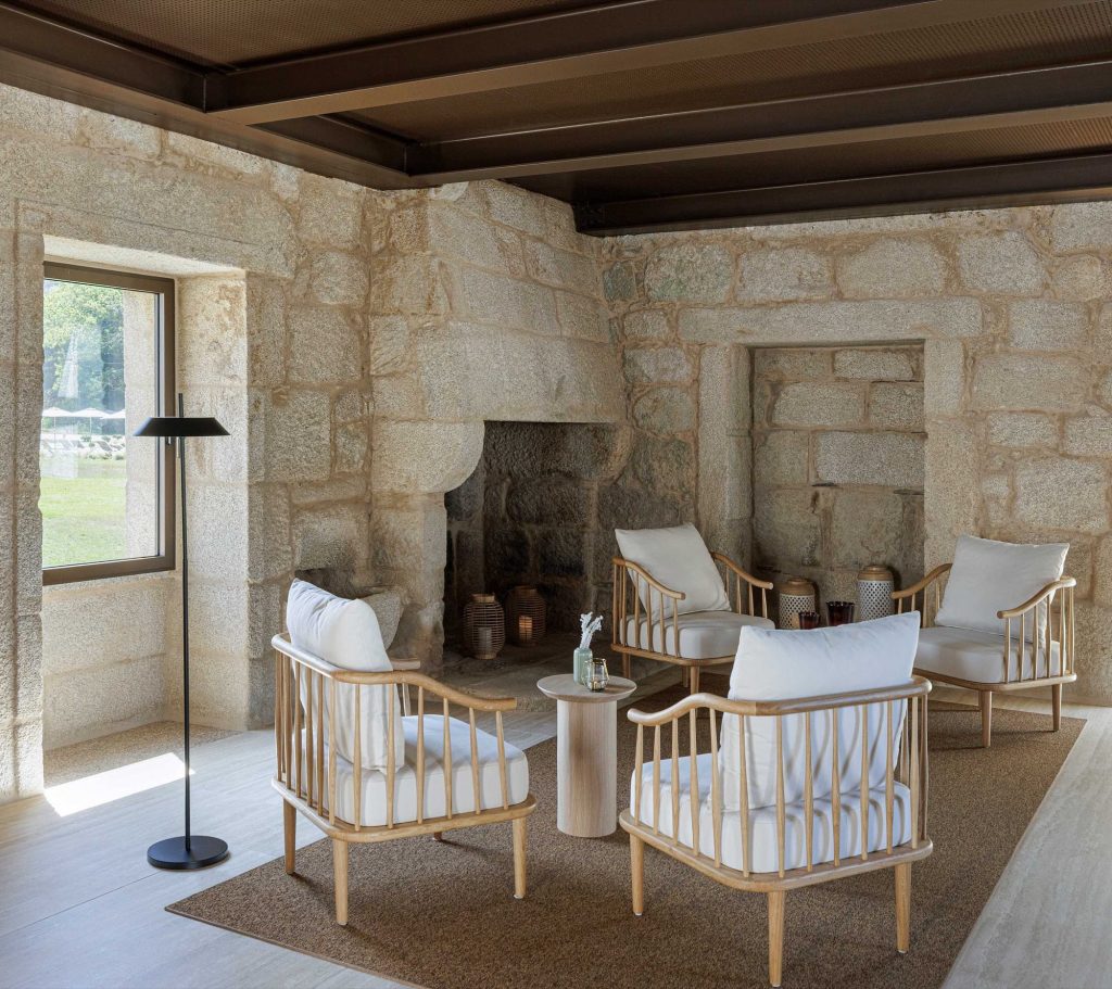 Lounge with stone walls and a dark timber ceiling