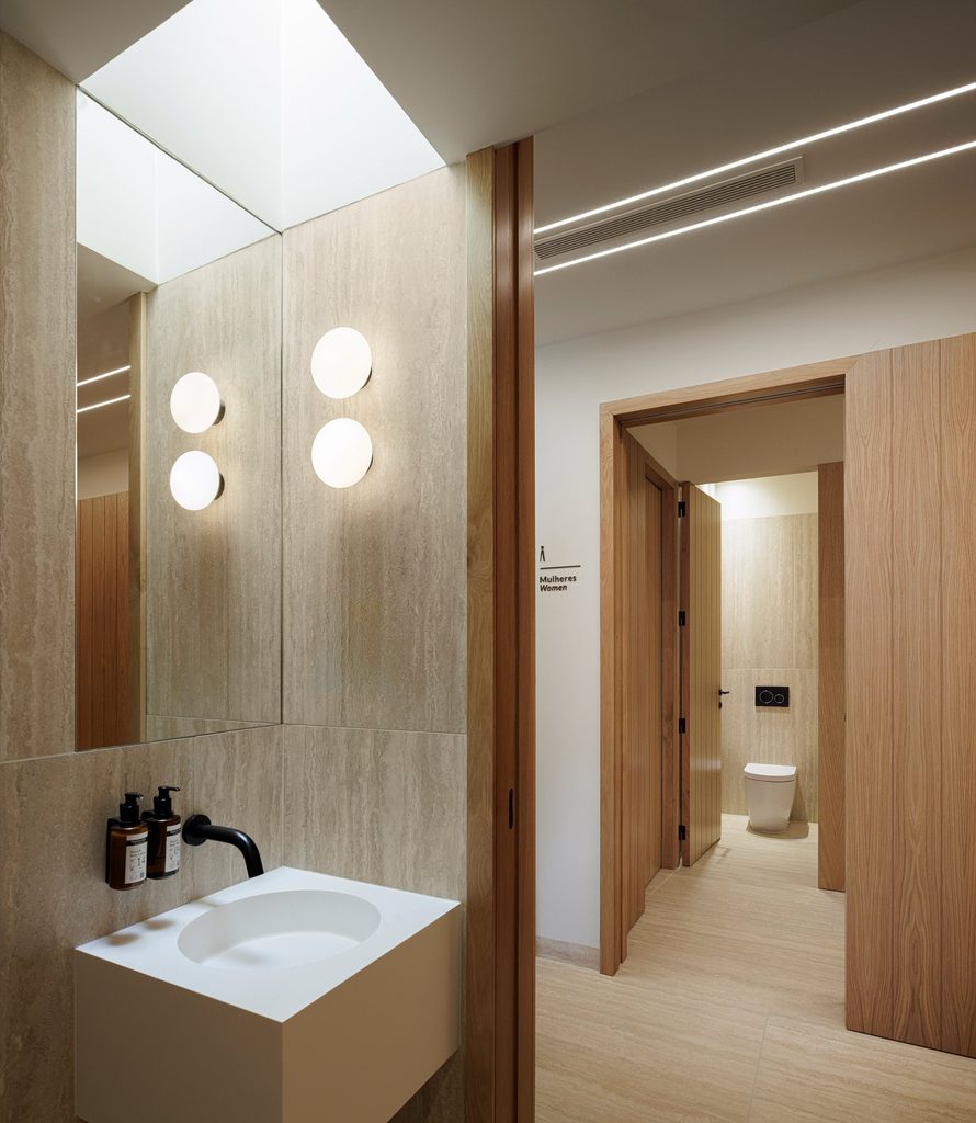 Washroom with timber doors and a backlit mirror
