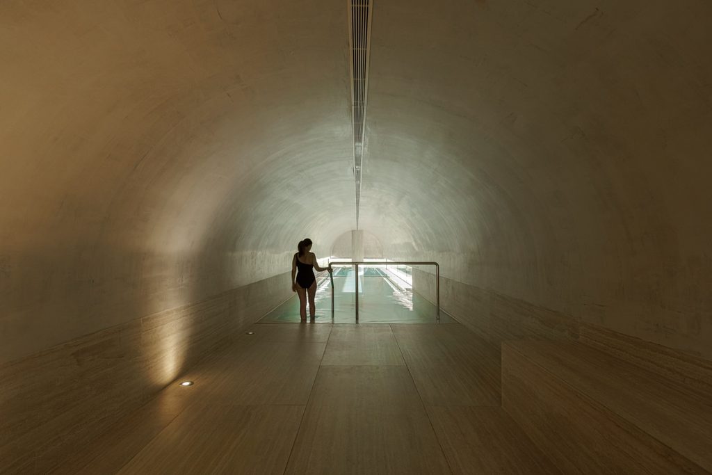 Vaulted spa walkway leading towards the indoor pool