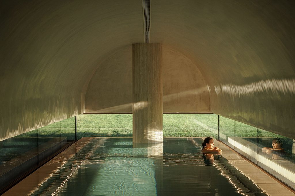 Indoor pool beneath a curved ceiling and central column