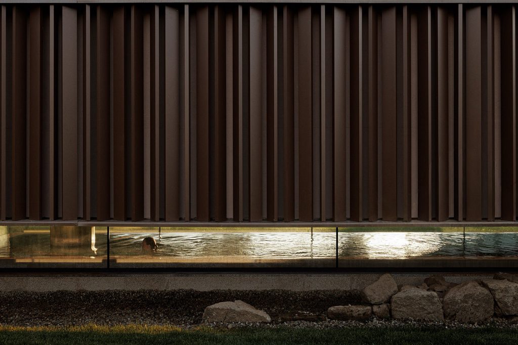 Illuminated masonry beneath the spa's glazed base