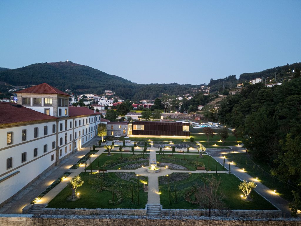 Monastery grounds and illuminated paths after sunset