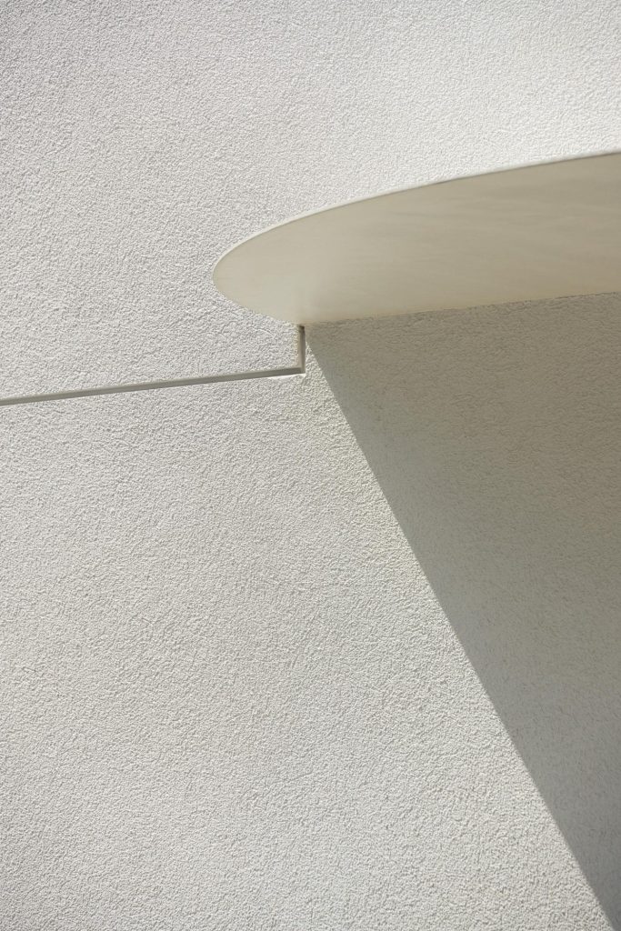 Textured white finish and a projecting entrance canopy