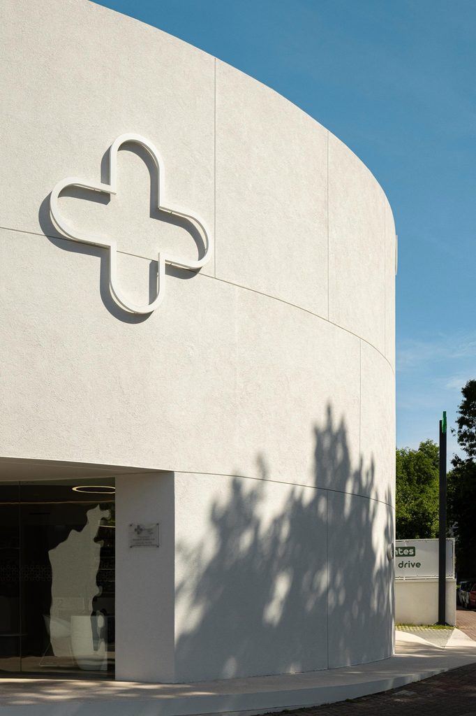 Pharmacy cross mounted on the curved facade