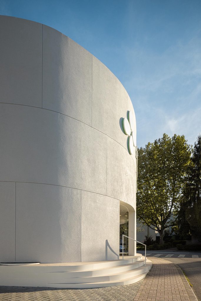 Rounded facade and entrance steps beside the pavement