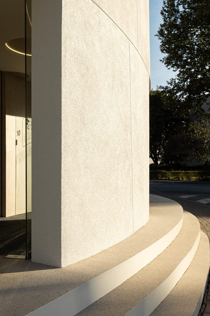 Curved entrance steps and facade in low sunlight