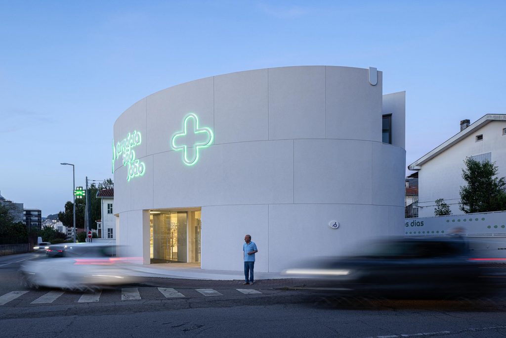 Illuminated cross on the curved street facade